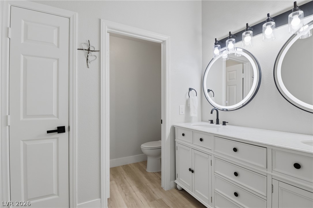 239 Highgate Street Henderson, NV 89074 - Photo 19 of 44 Retreat to a spa-inspired primary suite featuring a soaking tub, a beautifully tiled walk-in shower, dual vanities with upgraded countertops, & a spacious walk-in closet.