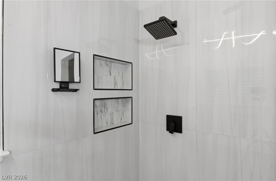 239 Highgate Street Henderson, NV 89074 - Photo 22 of 44 Retreat to a spa-inspired primary suite featuring a soaking tub, a beautifully tiled walk-in shower, dual vanities with upgraded countertops, & a spacious walk-in closet.