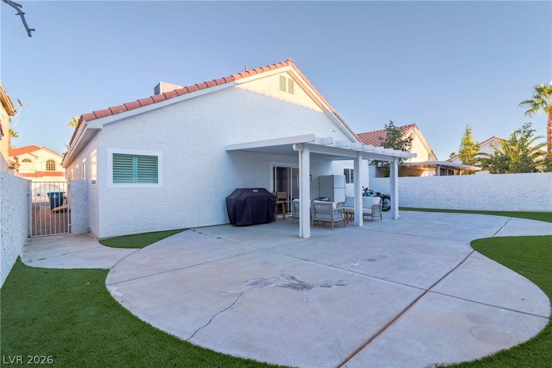 239 Highgate Street Henderson, NV 89074 - Photo 37 of 44 The backyard is perfect for entertaining with a covered patio & low-maintenance synthetic grass for simple enjoyment.
