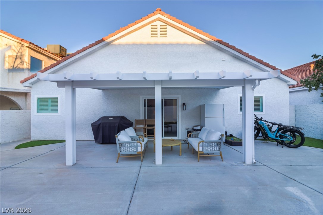 239 Highgate Street Henderson, NV 89074 - Photo 38 of 44 The backyard is perfect for entertaining with a covered patio & low-maintenance synthetic grass for simple enjoyment.
