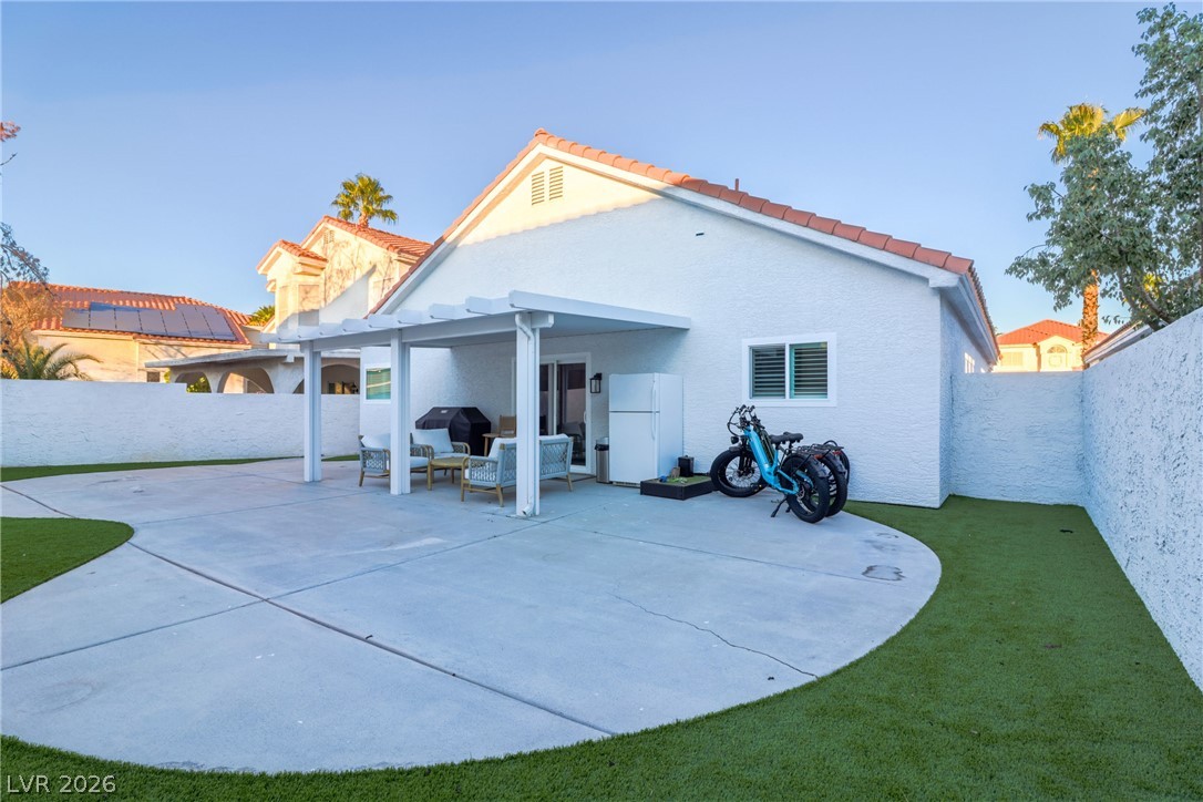 239 Highgate Street Henderson, NV 89074 - Photo 39 of 44 The backyard is perfect for entertaining with a covered patio & low-maintenance synthetic grass for simple enjoyment.