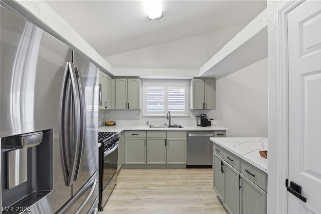 239 Highgate Street Henderson, NV 89074 - Photo 10 of 44 The chef’s kitchen is anchored by top-of-the-line stainless steel appliances, stunning quartz countertops, & striking custom cabinetry with designer hardware.