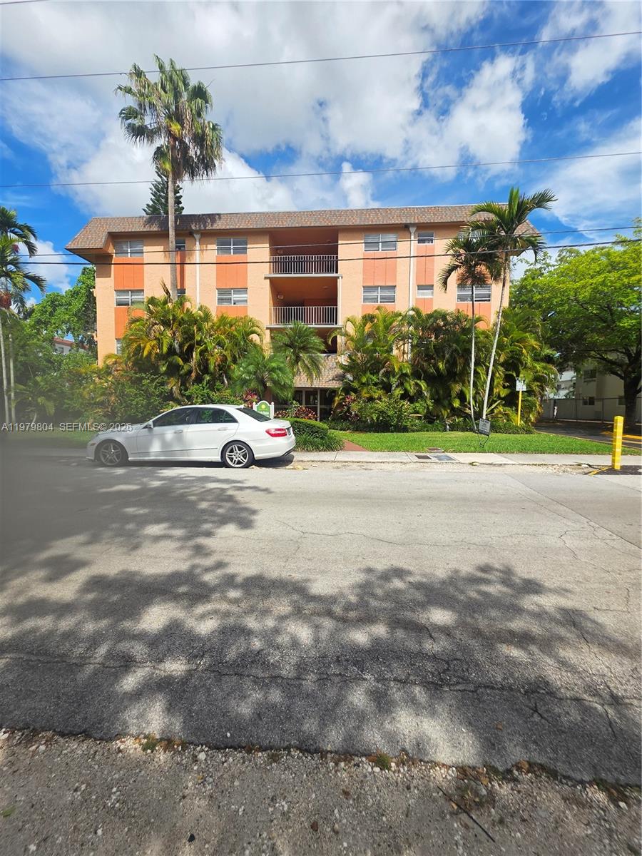 8101 Southwest 73rd Avenue, Unit 17 Miami, FL 33143 - Photo 19 of 66 a front view of a house with a yard and a garage