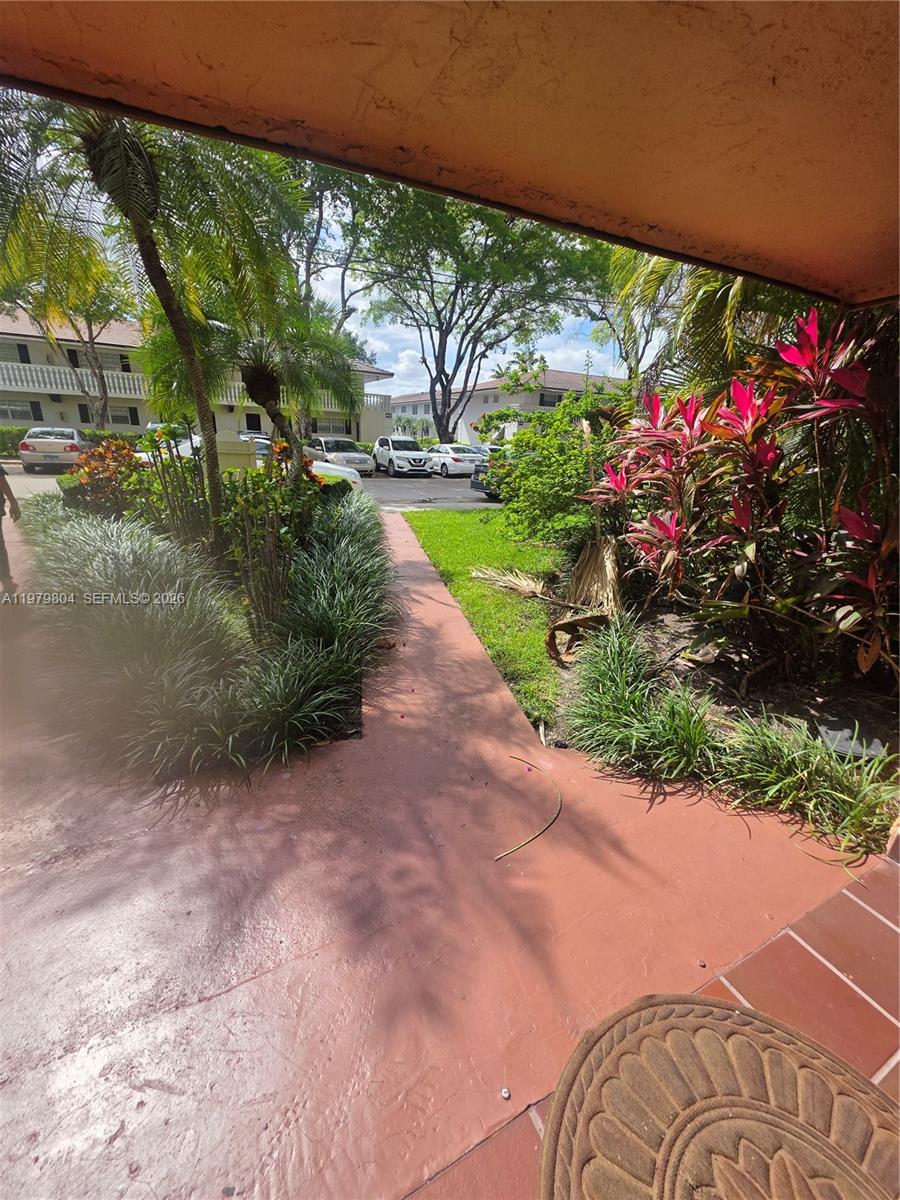 8101 Southwest 73rd Avenue, Unit 17 Miami, FL 33143 - Photo 21 of 66 a view of a garden with flowers and plants