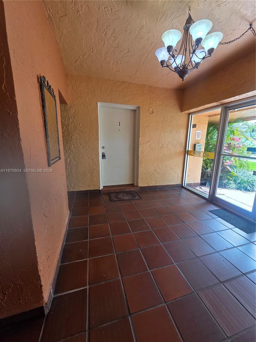 8101 Southwest 73rd Avenue, Unit 17 Miami, FL 33143 - Photo 24 of 66 a view of a livingroom with a floor to ceiling window and stairs