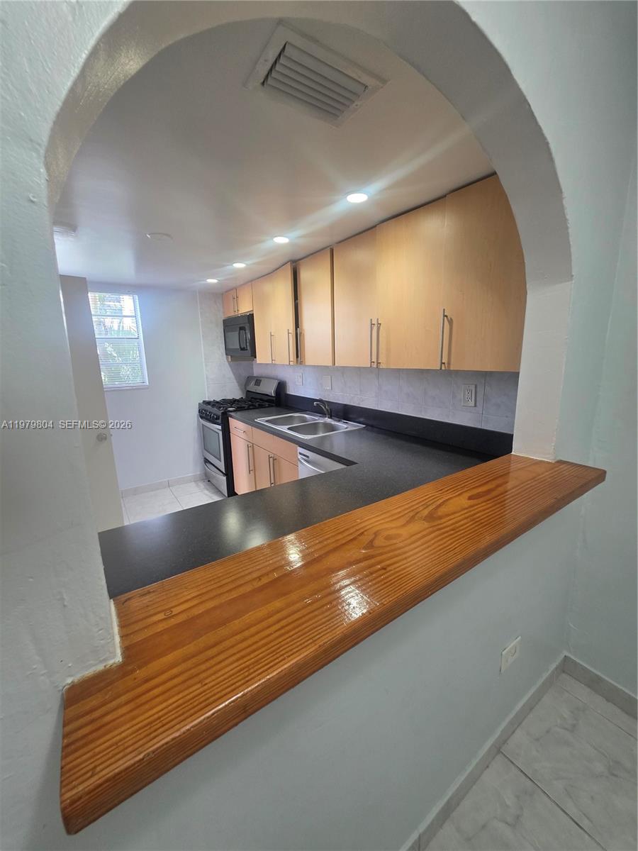 8101 Southwest 73rd Avenue, Unit 17 Miami, FL 33143 - Photo 25 of 66 a view of kitchen island with wooden floor
