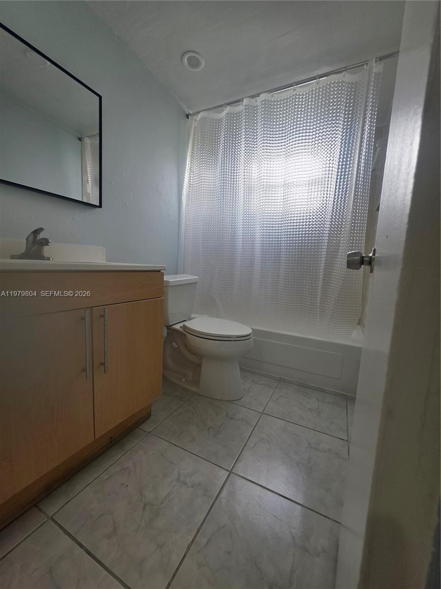8101 Southwest 73rd Avenue, Unit 17 Miami, FL 33143 - Photo 28 of 66 a bathroom with a sink a toilet and mirror