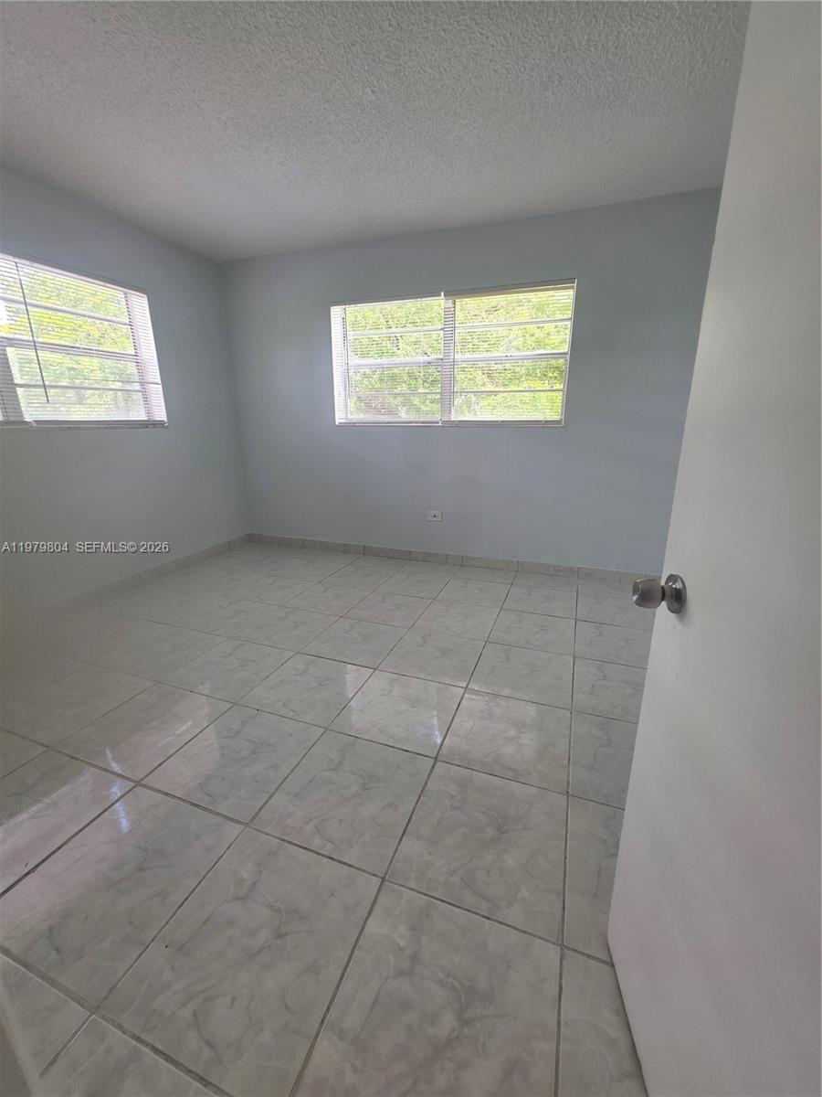 8101 Southwest 73rd Avenue, Unit 17 Miami, FL 33143 - Photo 30 of 66 a view of an empty room with a window