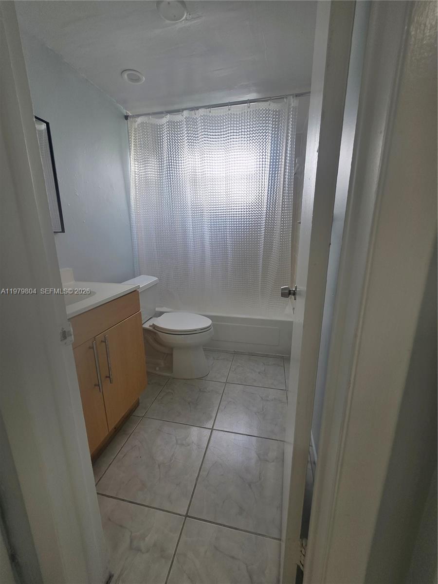 8101 Southwest 73rd Avenue, Unit 17 Miami, FL 33143 - Photo 34 of 66 a bathroom with a toilet a sink and shower