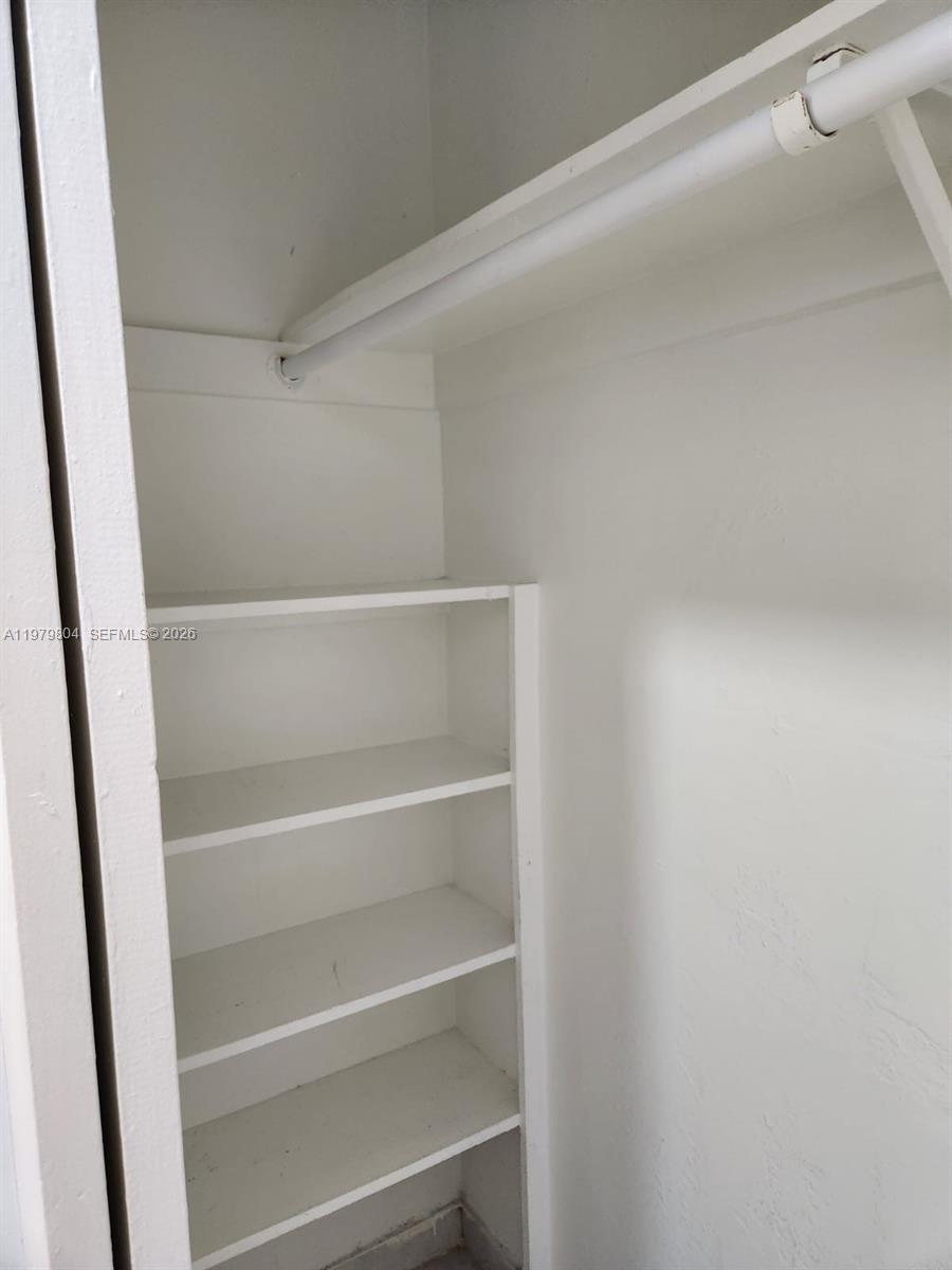 8101 Southwest 73rd Avenue, Unit 17 Miami, FL 33143 - Photo 4 of 66 a view of walk in closet with empty racks