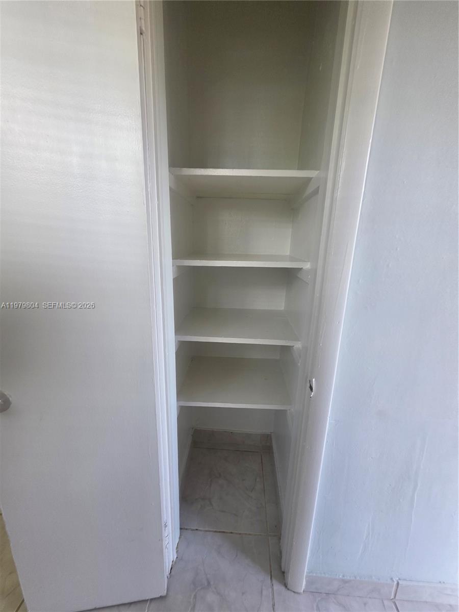 8101 Southwest 73rd Avenue, Unit 17 Miami, FL 33143 - Photo 46 of 66 a view of walk in closet with empty racks