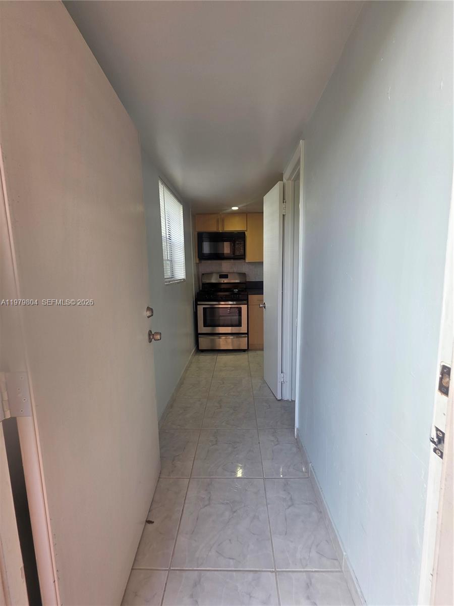 8101 Southwest 73rd Avenue, Unit 17 Miami, FL 33143 - Photo 47 of 66 a view of a hallway to rooms and stairs