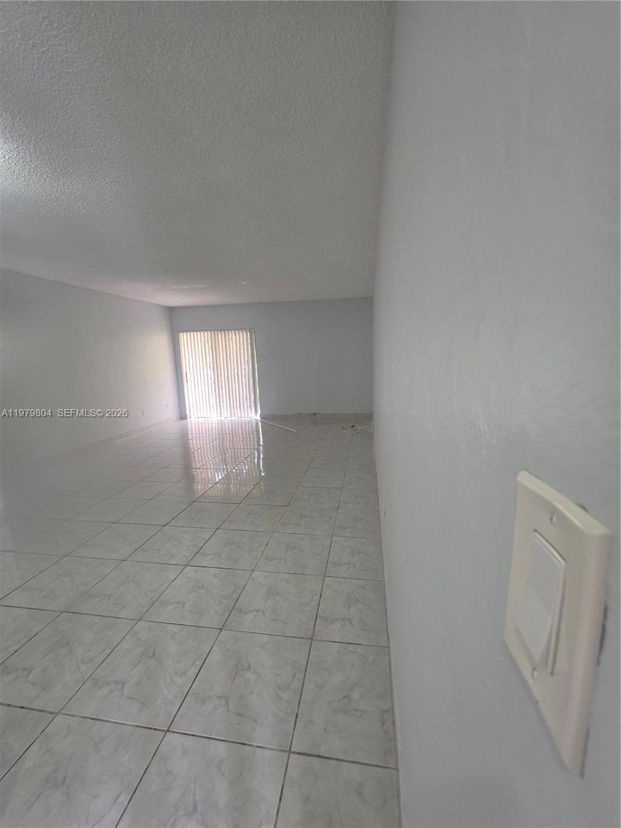 8101 Southwest 73rd Avenue, Unit 17 Miami, FL 33143 - Photo 56 of 66 a view of an empty room and a window