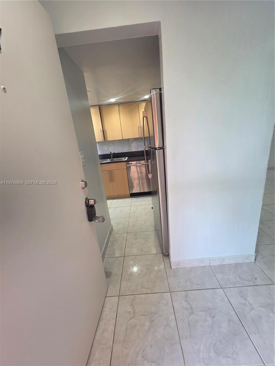 8101 Southwest 73rd Avenue, Unit 17 Miami, FL 33143 - Photo 58 of 66 a en suite bathroom with a granite countertop sink and a mirror