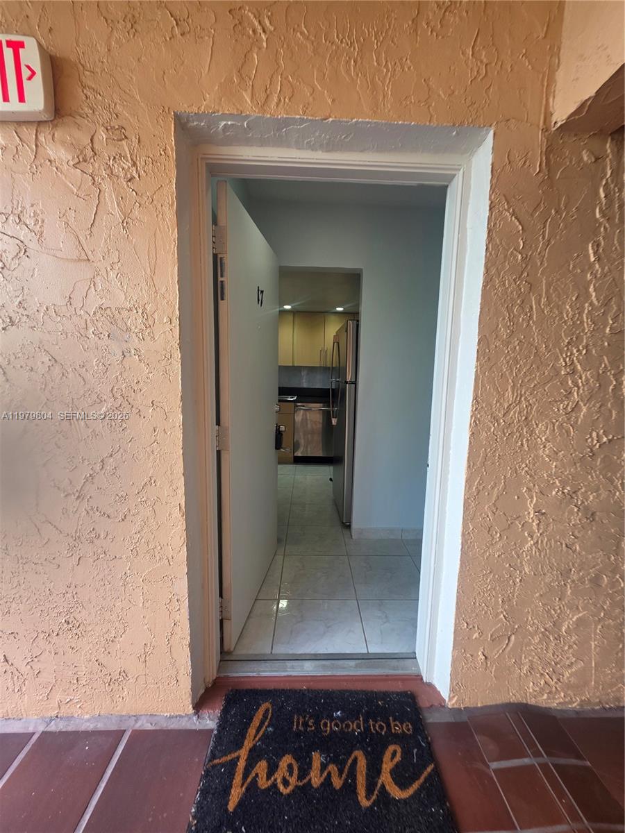 8101 Southwest 73rd Avenue, Unit 17 Miami, FL 33143 - Photo 60 of 66 a view of a hallway with wooden floor and a living room
