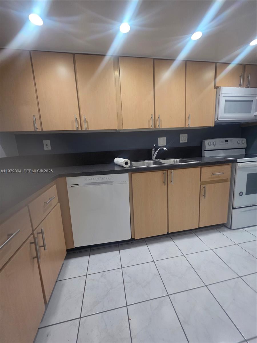 8101 Southwest 73rd Avenue, Unit 17 Miami, FL 33143 - Photo 66 of 66 a kitchen with stainless steel appliances a sink and a cabinets