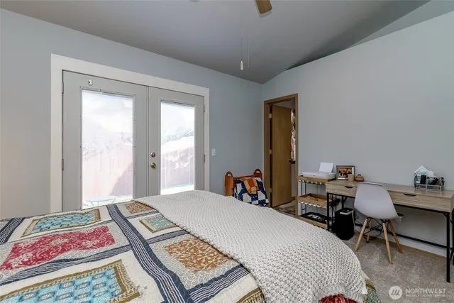 a bedroom with a bed a desk and chair