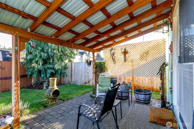 a building outdoor space with patio furniture and potted plants