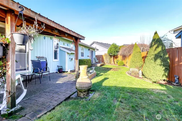a view of a house with backyard and sitting area