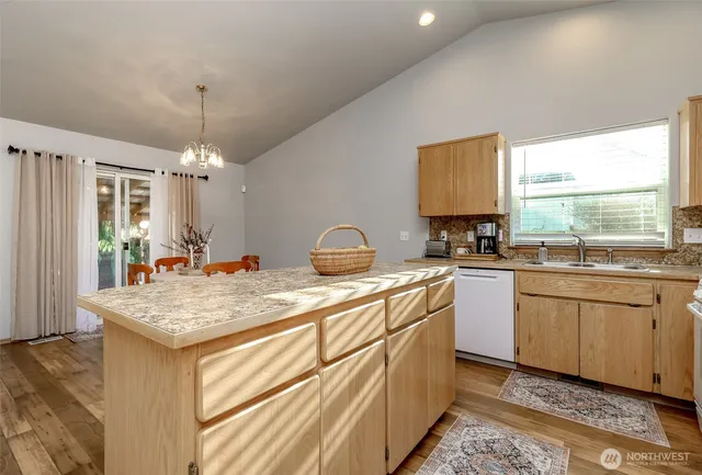 a kitchen that has a sink and a stove in it