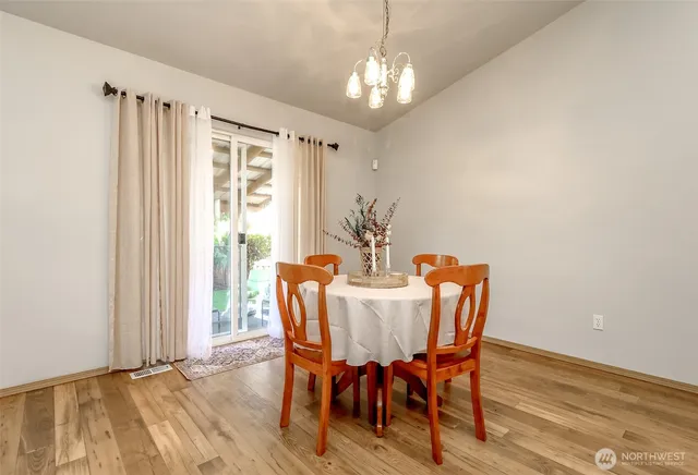 a view of a dining room with furniture window and wooden floor