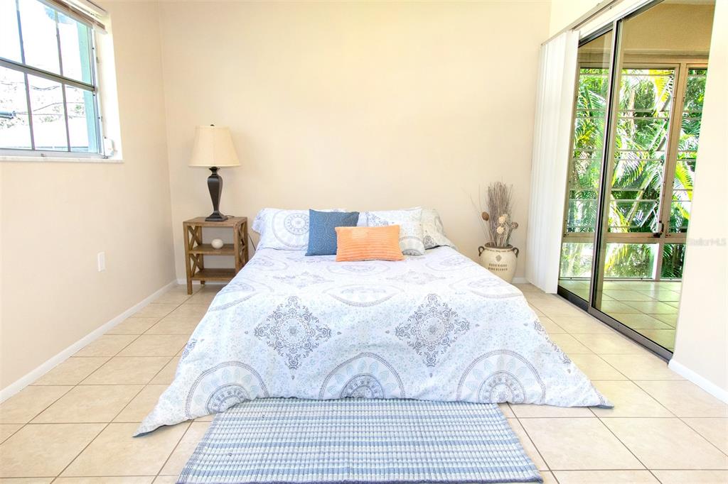 1433 South Belcher Road, Unit F11 Clearwater, FL 33764 - Photo 12 of 21 a bedroom with a bed and large window