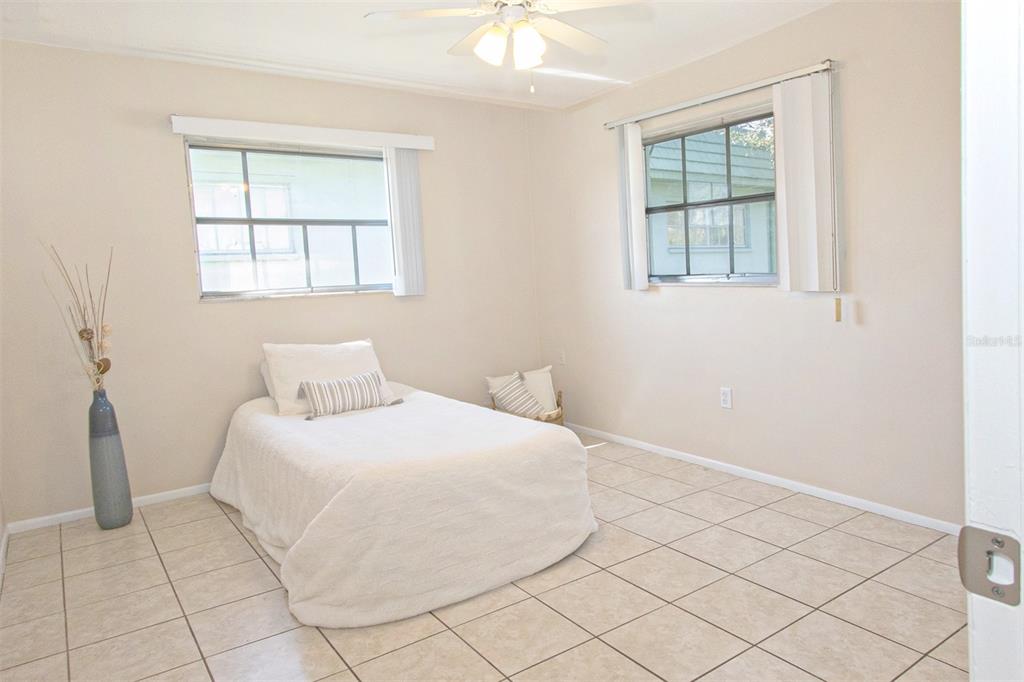 1433 South Belcher Road, Unit F11 Clearwater, FL 33764 - Photo 16 of 21 a bedroom with a bed and a window