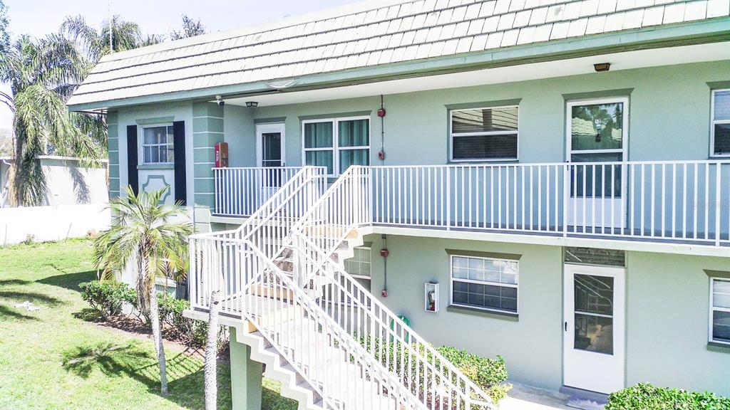 1433 South Belcher Road, Unit F11 Clearwater, FL 33764 - Photo 3 of 21 a view of a house with large windows and couches