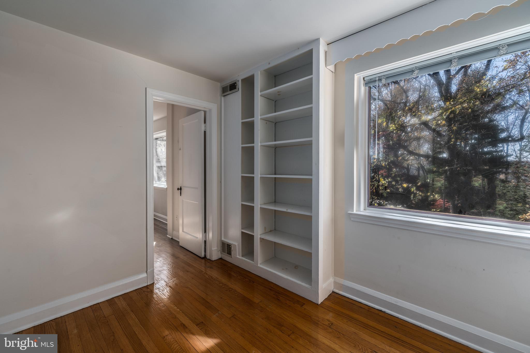 1012 Poplar Hill Road Baltimore, MD 21210 - Photo 22 of 42 a view of a room with wooden floor and windows