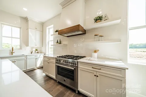 a kitchen with a stove oven and sink