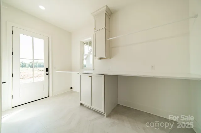a view of a livingroom with furniture and a potted plant