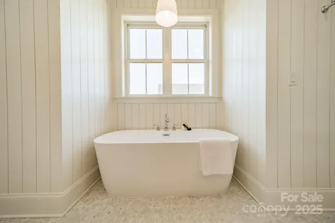 a large bathroom with a double vanity sink mirror and bathtub