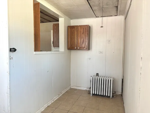 a view of a door and wooden floor