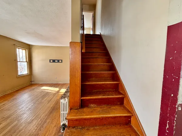 a view of an entryway with wooden floor