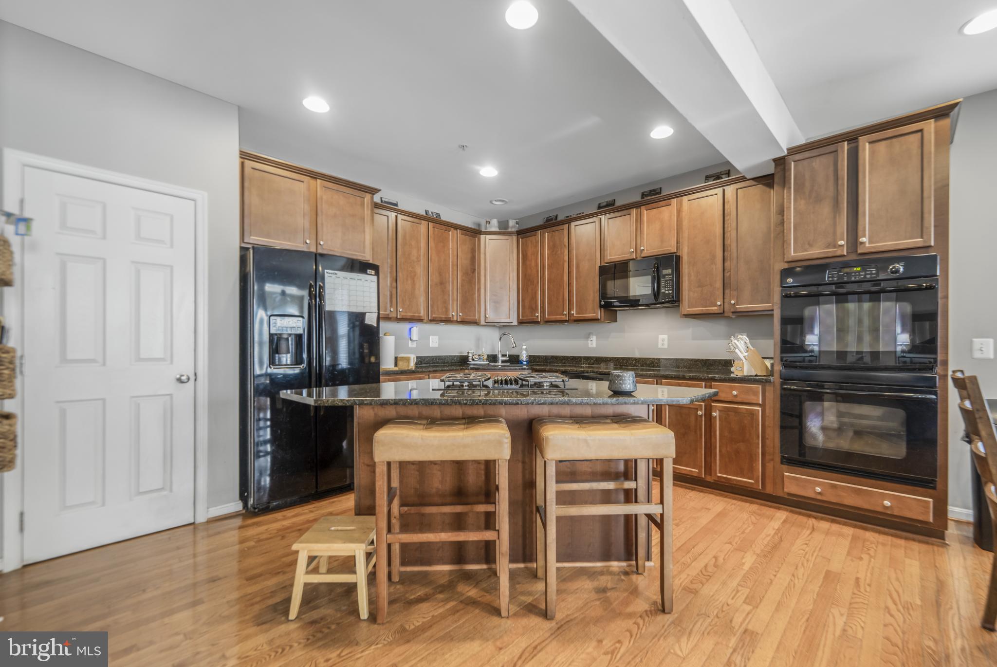 9709 Traver Street Bowie, MD 20721 - Photo 12 of 48 Modern kitchen with rich wood cabinetry.