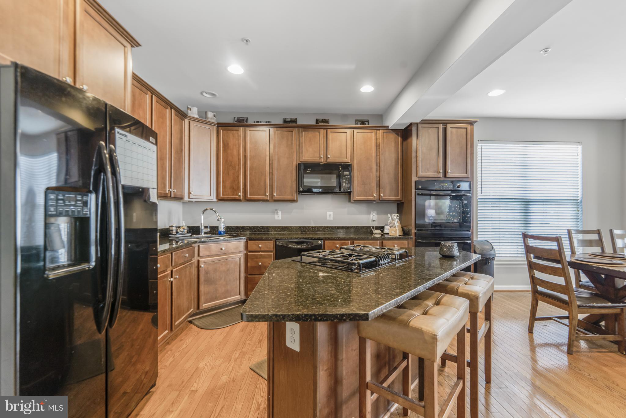 9709 Traver Street Bowie, MD 20721 - Photo 14 of 48 Modern kitchen with rich wood cabinetry.