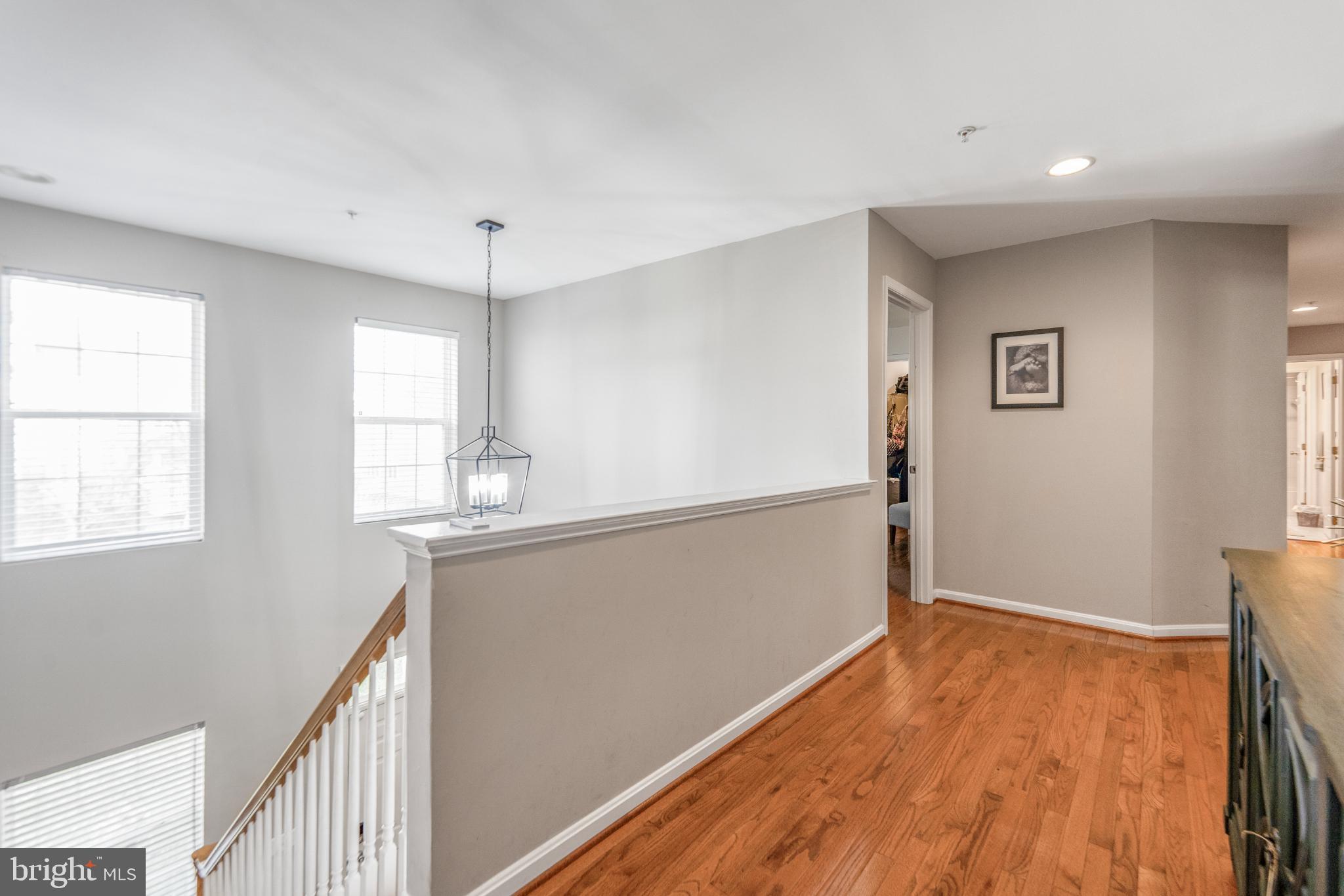 9709 Traver Street Bowie, MD 20721 - Photo 21 of 48 Bright and airy hallway with warm wood floors.