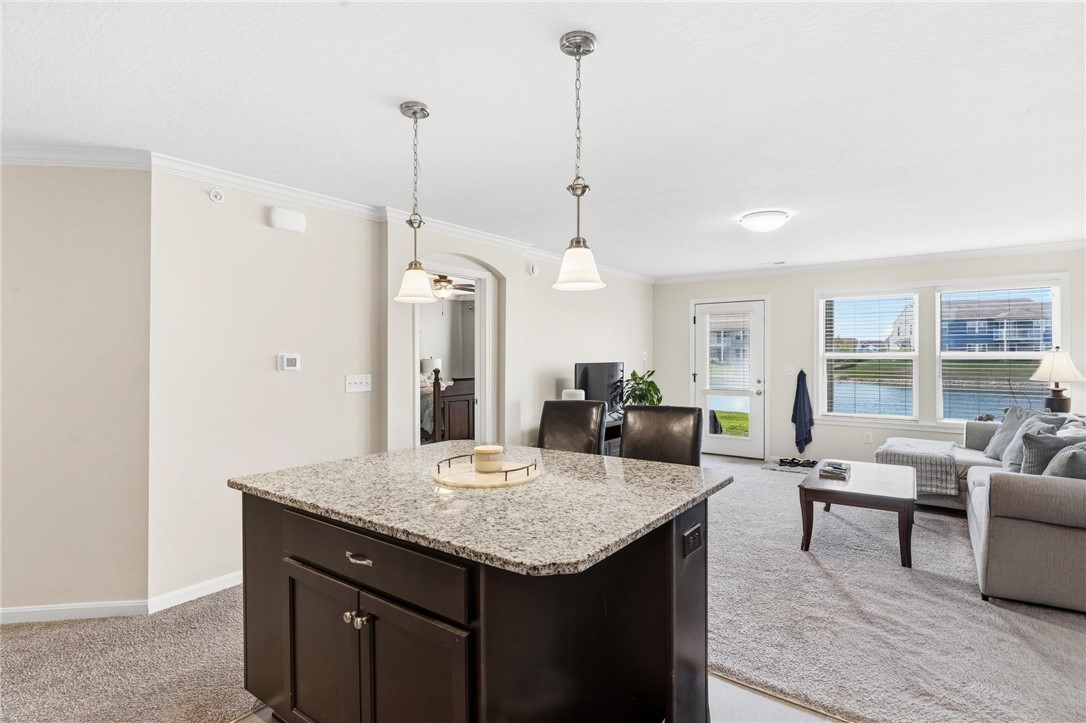 141 Old Pond Road Springboro, OH 45066 - Photo 10 of 20 This bright living space features a kitchen island and scenic water views.