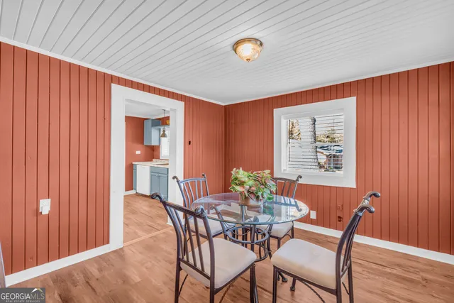 a kitchen with a sink a refrigerator and wooden floor