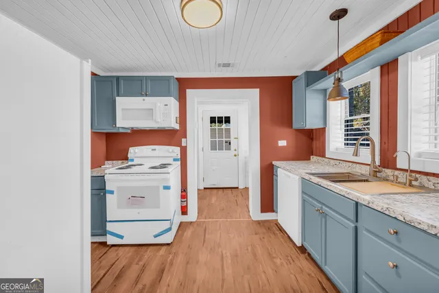 a kitchen with a stove and a refrigerator