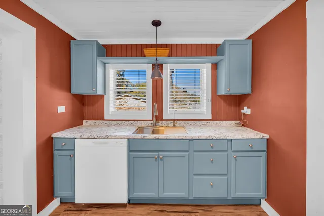 a kitchen with a sink stove and refrigerator