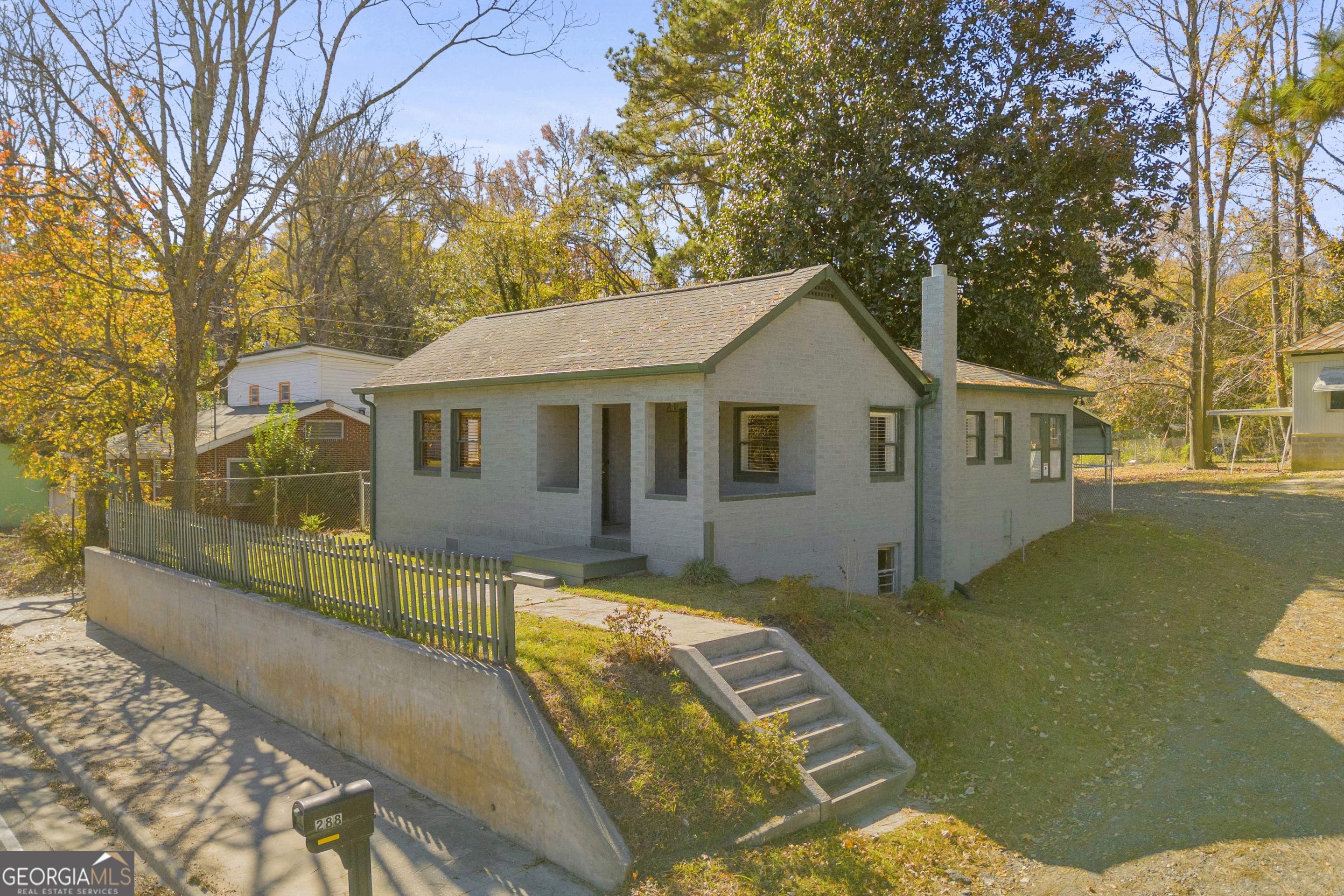 288 South Broad Street Toccoa, GA 30577 - Photo 2 of 23 a front view of a house with a yard table and chairs