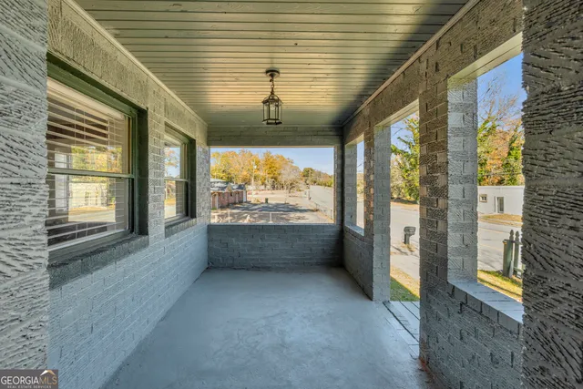 a view of an entryway with wooden floor and door