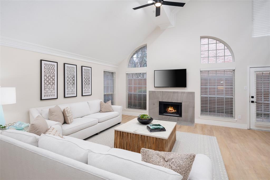 14604 Hemingway Court Addison, TX 75001 - Photo 5 of 27 a living room with furniture a fireplace and a flat screen tv