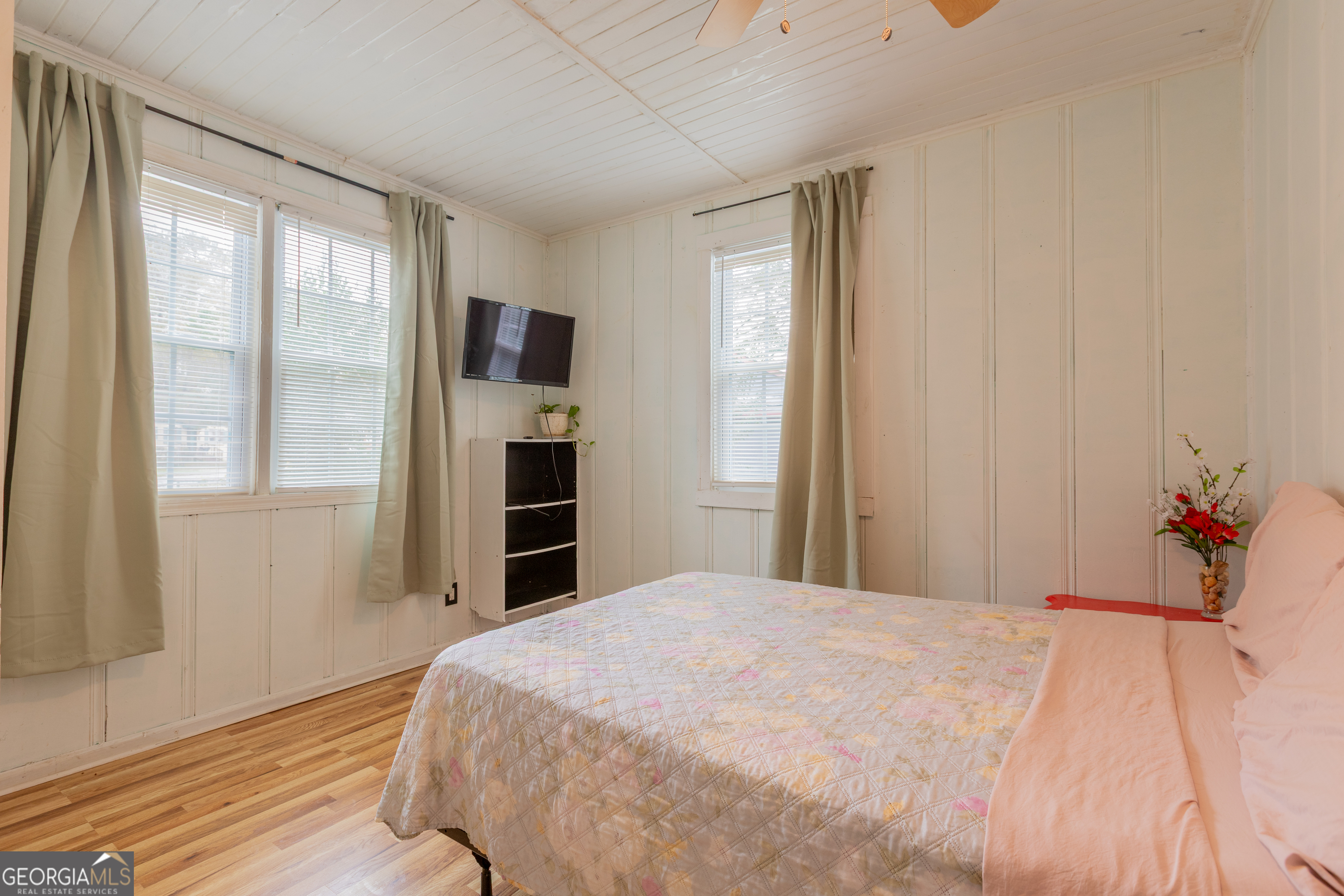 1103 Calvin Avenue Columbus, GA 31903 - Photo 13 of 15 a bedroom with a large bed and a flat tv screen