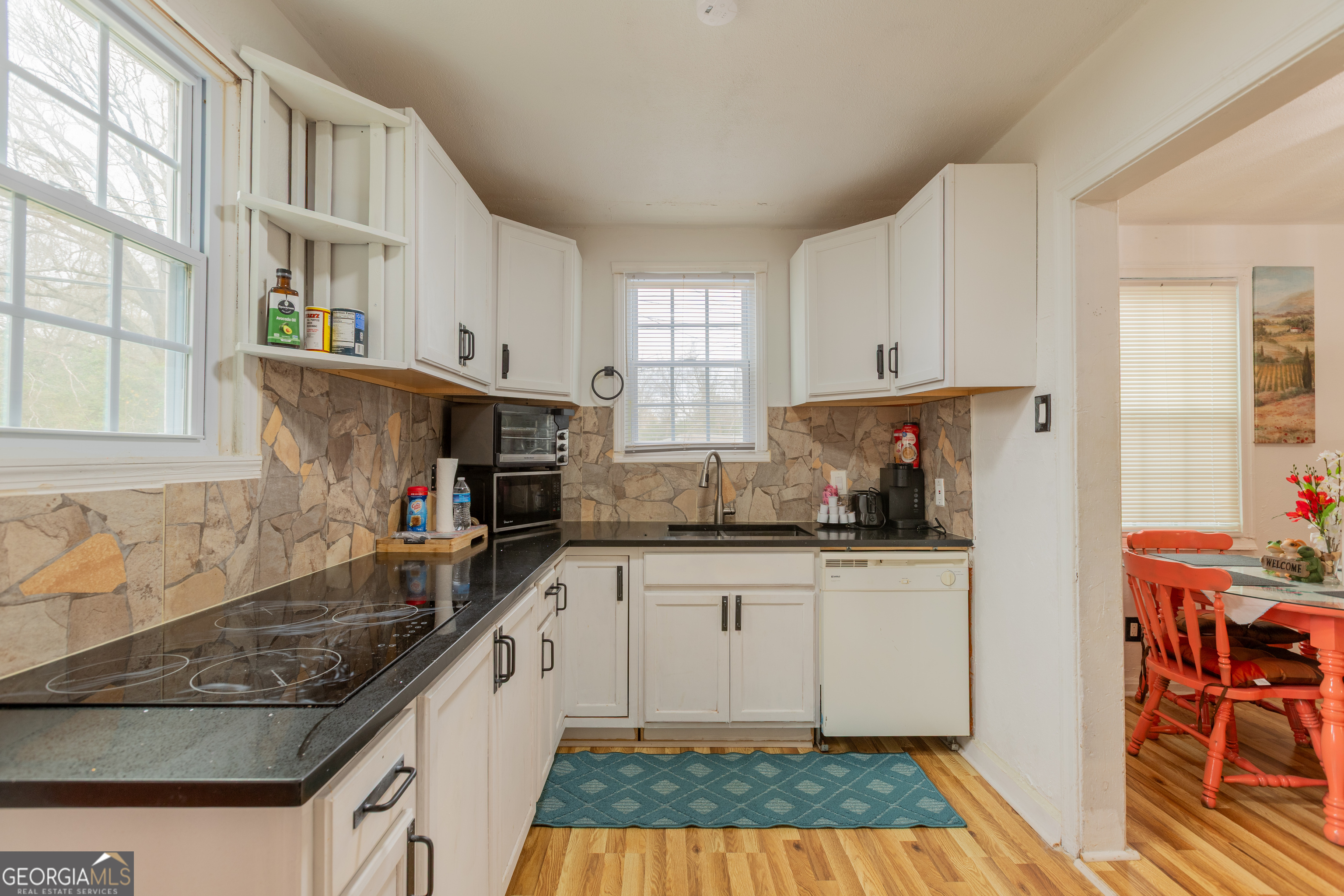 1103 Calvin Avenue Columbus, GA 31903 - Photo 8 of 15 a kitchen with granite countertop stainless steel appliances a sink a stove a refrigerator cabinets and a window