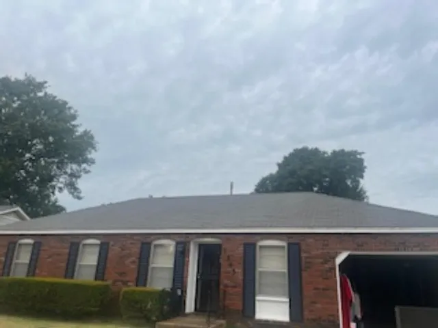a view of house with a yard