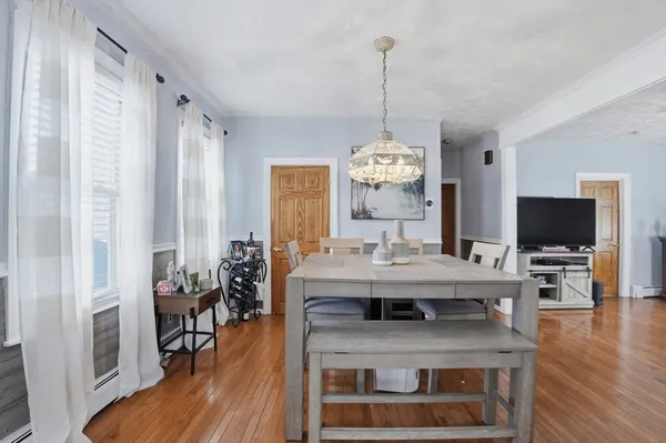 a view of living room with furniture and wooden floor