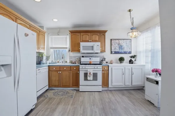 a kitchen with a white cabinets and white appliances