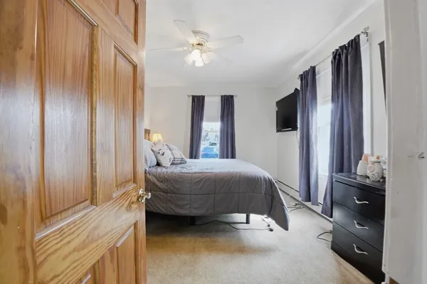 a bedroom with a bed and a chandelier